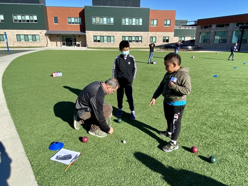 H.O. Brittingham Elementary and Sussex Consortium students participated in a Special Olympics unified bocce tournament Nov. 5. Physical education teacher Bill Funkhouser measures the distance from the ball to the pallino under the watchful eyes of fifth-grader Nathan Yuan, center, and third-grader Devon Cooper. ELLEN DRISCOLL PHOTOS